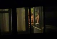 Filmed through the window as a girl masturbates at home