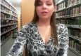 Female student in the library on webcam