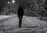 She walks with a Lantern in the ass on a winter street