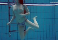 Redhead Lisa Bubarek takes off her swimsuit swimming underwater