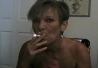 Mature with short hair sucks under a cigarette